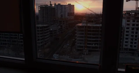 Construction of blocks, buildings in the city, the background of a sunset. Stock Footage 127849255