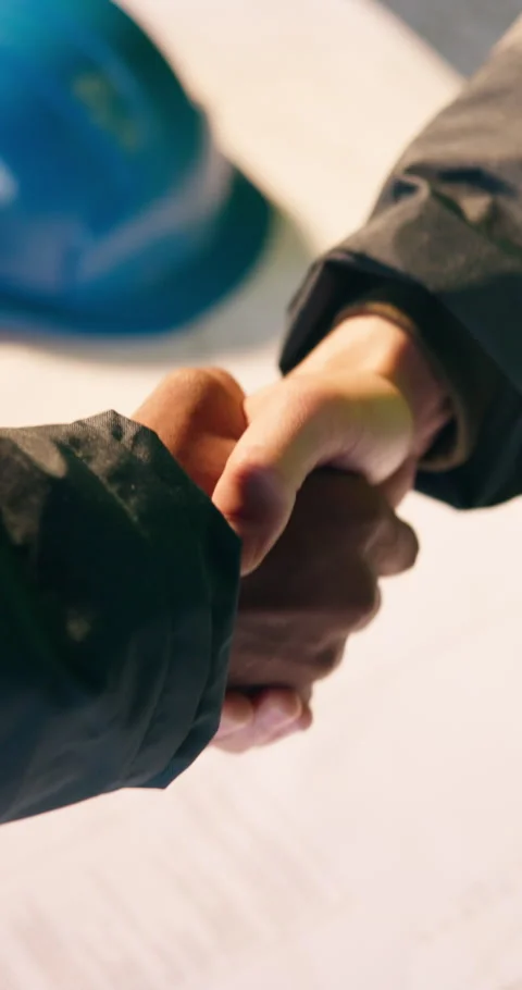 Construction, blueprint and people with handshake for meeting, agreement and Stock Footage 340870029