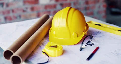 Construction, blueprint and tools with helmet on table for development, layout Stock Footage 336795489