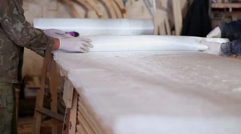 Construction of boats at the shipyard, carpenters work with fiberglass Stock Footage 60224580