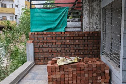 Construction of brick masonry with red mud bricks. 스톡 사진