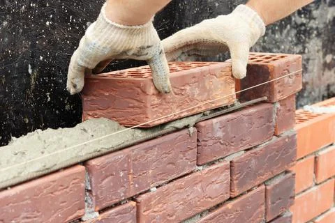 Construction of a brick wall. Brick laying. selective focus Stock Photos