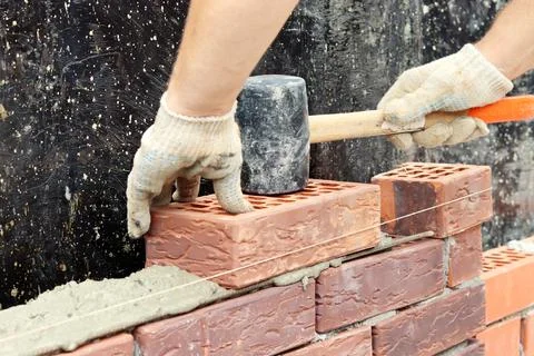 Construction of a brick wall. Brick laying. selective focus Stock Photos