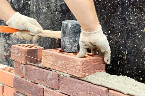 Construction of a brick wall. Brick laying. selective focus Stock Photos