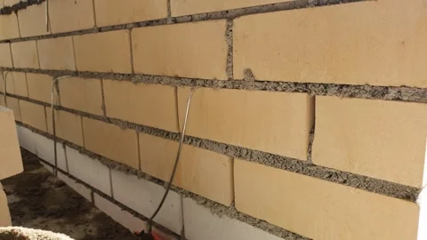 Construction of a brick wall POV. Brickwork of residential, apartment building. Stock Footage 244391871