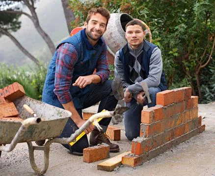 Construction, bricklayer in portrait and men with brick wall, handyman or Stock Photos