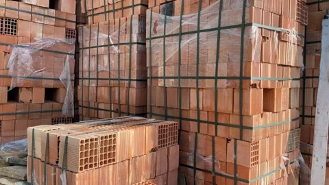Construction bricks stacked at a site with various shapes and textures visibl Stock Footage 329785285