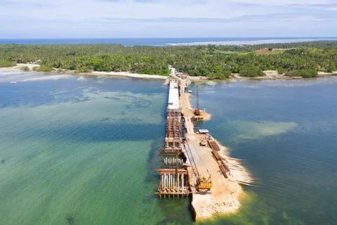 Construction of a bridge across the bay. Construction equipment on the bridge Stock Photos