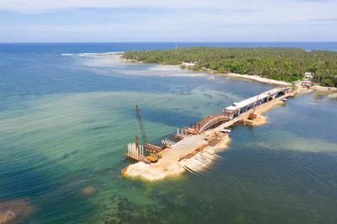 Construction of a bridge across the bay. Construction equipment on the bridge Stock Photos