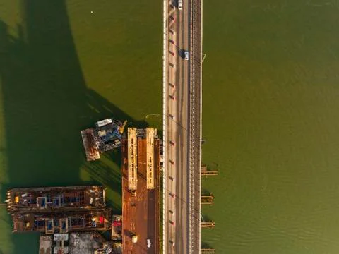 Construction of the bridge across the river. Stock Photos