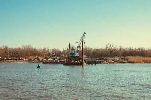 Construction of a bridge across the river. Stock Photos