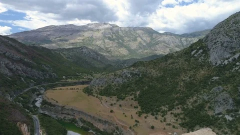 Construction of bridge columns of a new highway through the Moraca canyon in Stock Footage 78496965