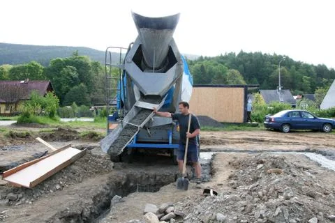 Construction builder and concrete mixer Stock Photos