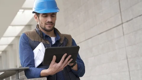 Construction builder outdoors with tablet and blueprints Stock Footage 100661335