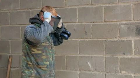 Construction builder puts a protective mask on his face. Protect your ears with Stock Footage 69041814