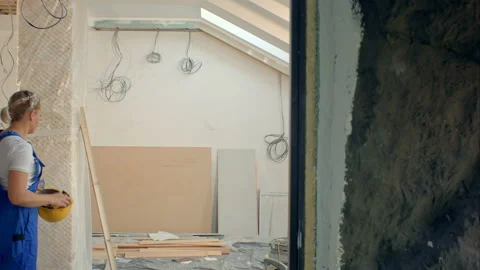 Construction builders makin repairs in apartment. Masters work with paint drill Stock Footage 91236415