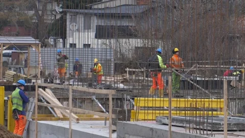 Construction builders work at the construction site in protective uniforms Stock Footage 146790923