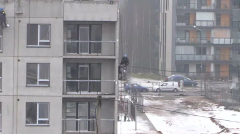 Construction builders work on house hanging with rope Stock Footage 52883184