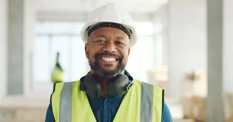 Construction, building and construction worker, man and smile in portrait Fotos de archivo