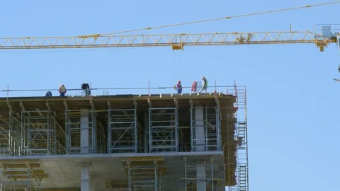 Construction of a building and a yellow crane Stock Footage 96178372