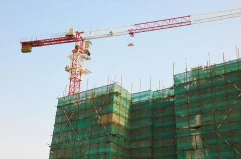 Construction of the building with a crane Stock Photos