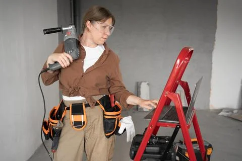 Construction, building, improvement or remodel concept. DIY woman in home d.. Stock Photos