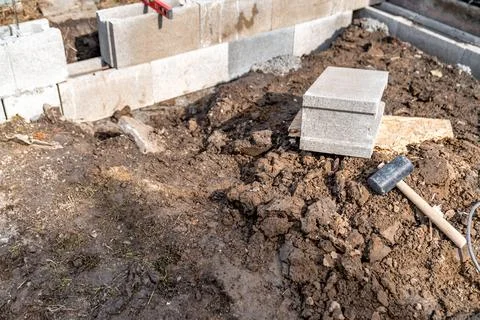 Construction of a building made of concrete bricks. using a hammer and spirit 写真素材