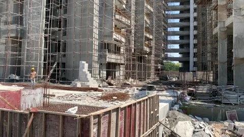 Construction building with tower cranes and people at work Video stock 240602728