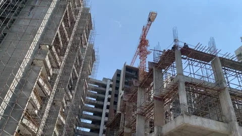 Construction building with tower cranes and people at work Stock Footage 240602807