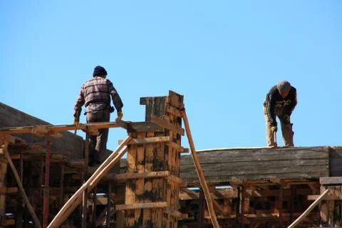 Construction of building with two workers Stock Photos