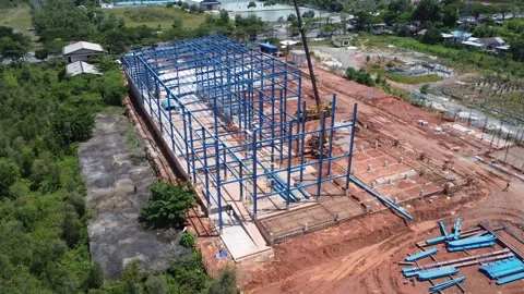Construction of a building using iron as the frame, with cranes located aro.. Stock Footage 327996185