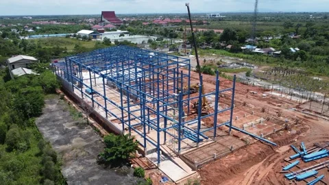 Construction of a building using iron as the frame, with cranes located aro.. Stock Footage 327996207