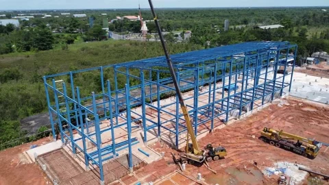 Construction of a building using iron as the frame, with cranes located aro.. Stock Footage 327996346