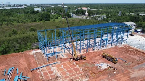 Construction of a building using iron as the frame, with cranes located aro.. Stock Footage 327996419