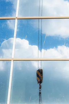 Construction of buildings: a crane hook, chains and cables on the background  Stock Photos
