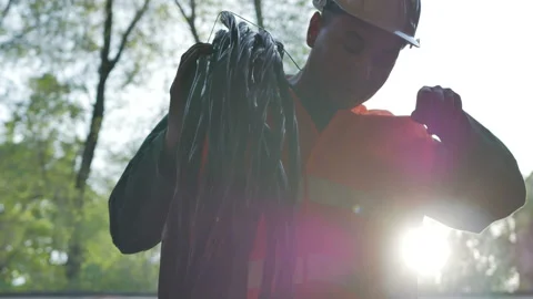 Construction cable worker helmet on checking coil of wires Stock Footage 89231990