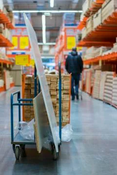 Construction cart in the building store. Carts loaded with boards. shop of bu Fotos de archivo