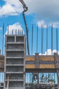 The construction, cement pouring with machine into the frame of the house, wo Fotos Stock