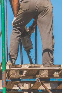 The construction, cement pouring with machine into the frame of the house, wo 写真素材