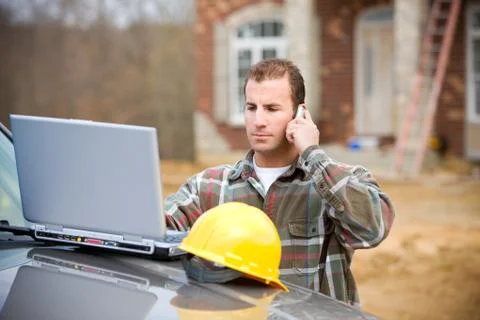 Construction: checking something with manager on phone Stock Photos