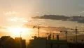 Construction city cranes over city buildings sunset timelapse background HD Footage