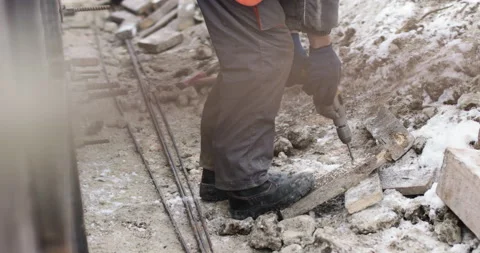 A construction company worker drills a hole in a wooden board. Work on the Video stock 145348518