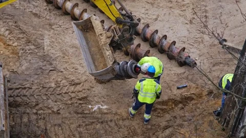 Construction Company Worker Preparing Long Industrial Drill For Pile Driver Stock Footage 268513196