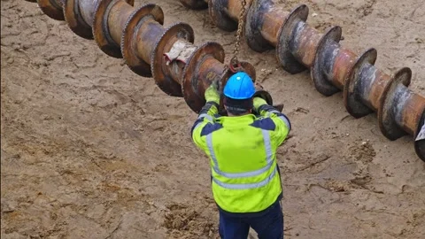 Construction Company Worker Preparing Long Industrial Drill For Pile Driver Stock Footage 268555492