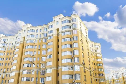 Construction complex high rise yellow residental apartment buildings with man Stock Photos