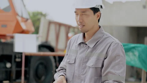 Construction concept of 4k resolution. Asian male engineer giving radio com.. Video stock 312698345