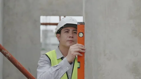 Construction concept of 4k resolution. Asian male engineer using ruler to m.. Stockbeeldmateriaal 329189767