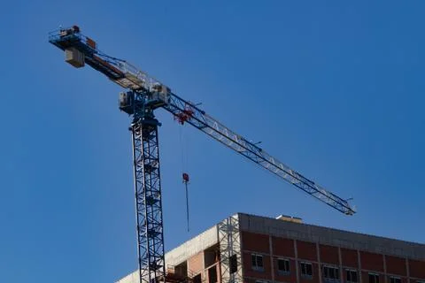 Construction concept: a crane building a multi-storey building Stock Photos