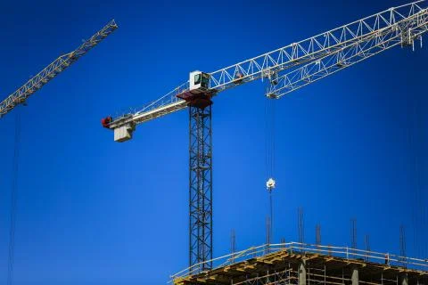 Construction concept. A new building under construction against the sky. Blue Stock Photos