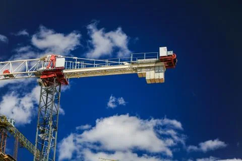 Construction concept. A new building under construction against the sky. Blue Stock Photos